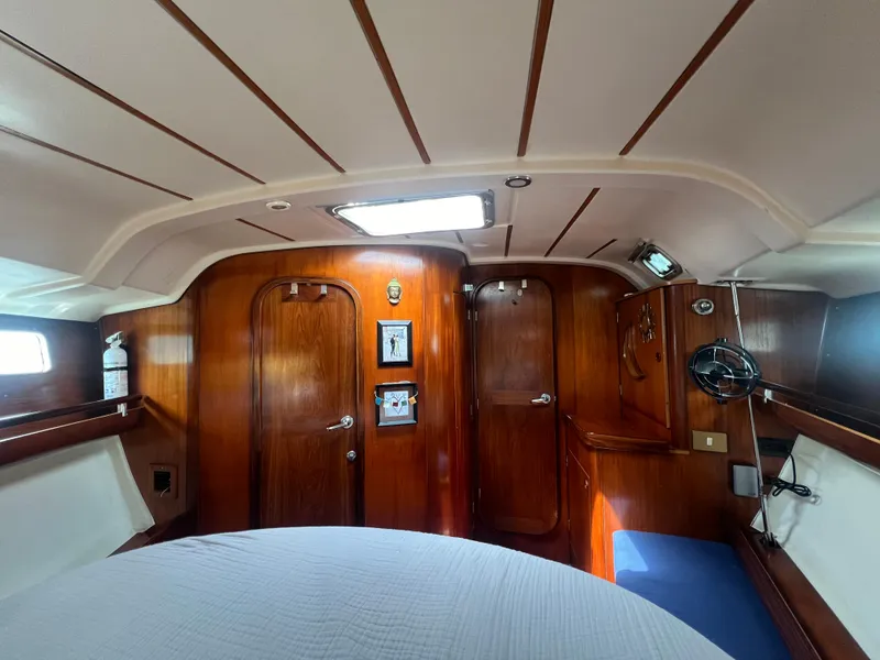 Slide: The Image of 1994 Beneteau Oceanis 440 cabin interior with wooden finish and cozy seating area. - 11