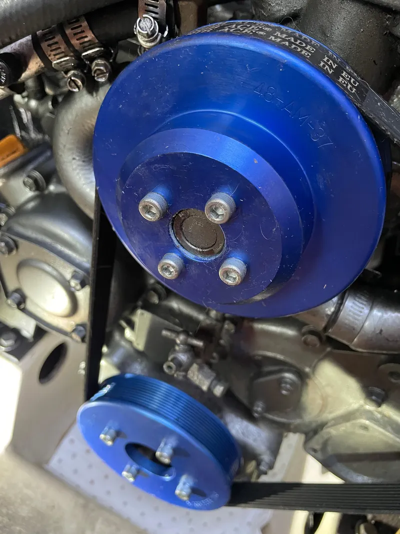 Slide: The Image of Close-up of a Beneteau Oceanis 440 engine component with blue pulleys, 1994 model. - 19