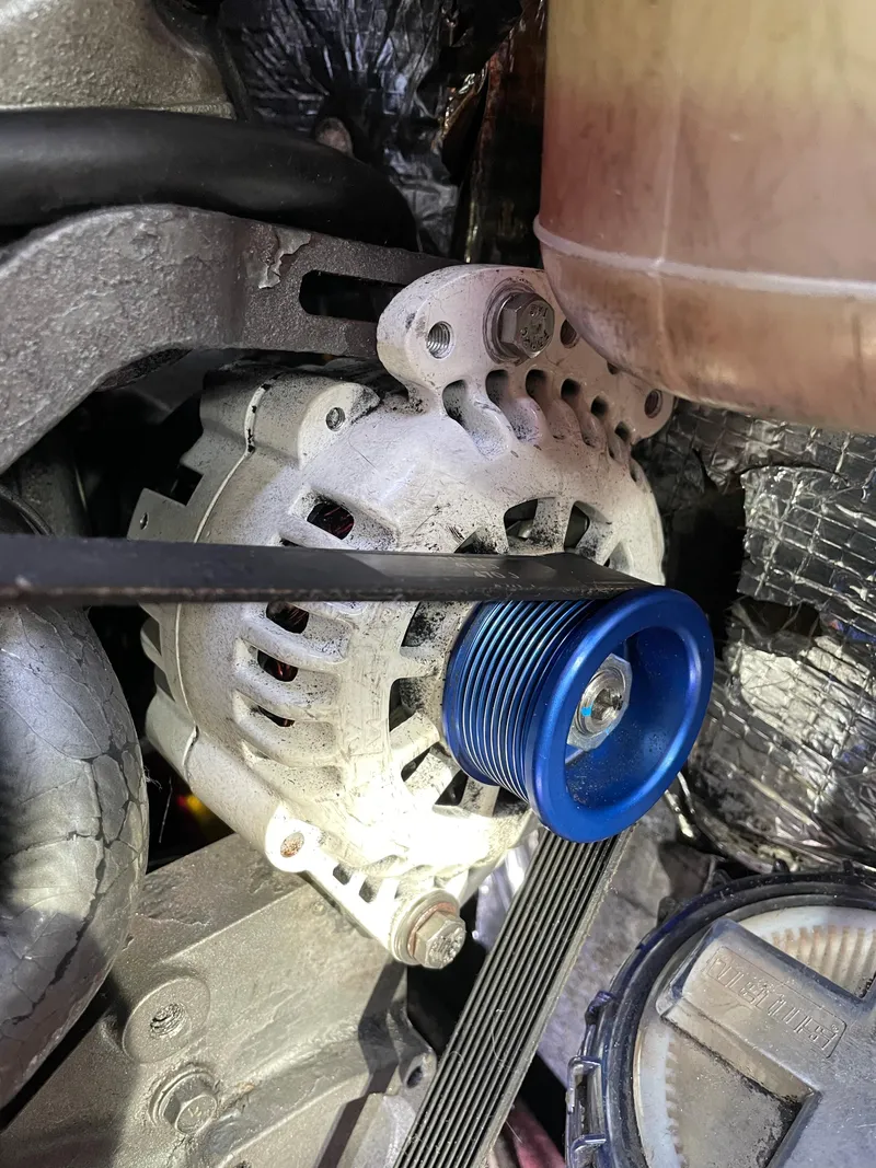 Slide: The Image of Alternator with blue pulley in a 1994 Beneteau Oceanis 440 sailboat engine compartment. - 20