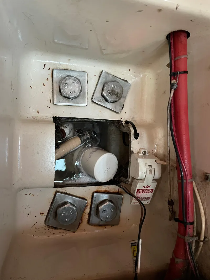 Slide: The Image of Bilge area of 1994 Beneteau Oceanis 440 sailboat with visible bolts and wiring. - 24