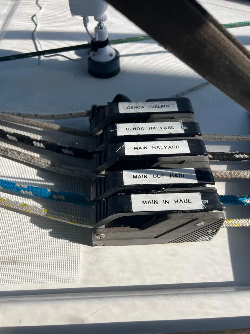 Slide: The Image of Close-up of labeled rope clutches on a 1994 Beneteau Oceanis 440 sailboat. - 25
