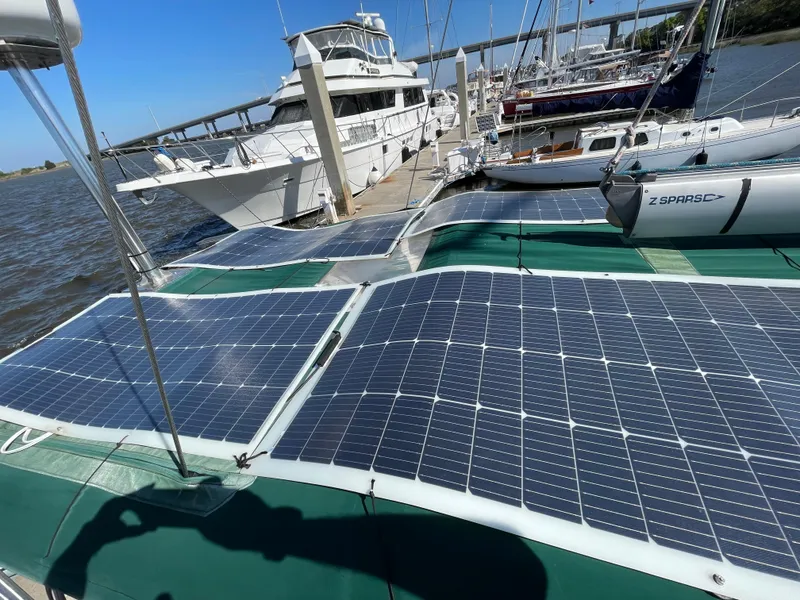 Slide: The Image of Sailboat with solar panels docked, Beneteau Oceanis 440, 1994 model, sunny marina setting. - 29
