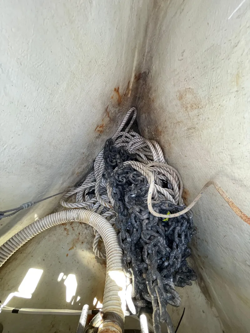 Slide: The Image of Anchor chain and ropes in the bow compartment of a 1994 Beneteau Oceanis 440 sailboat. - 33