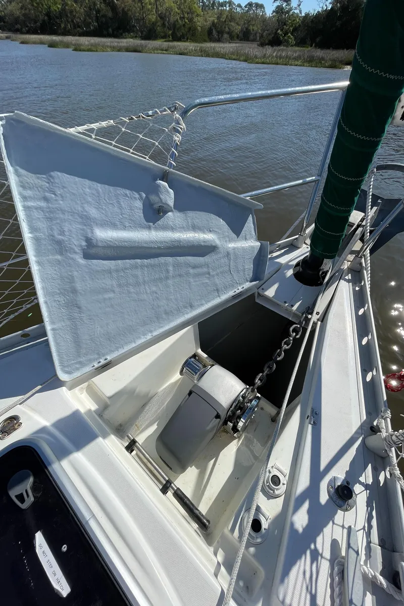 Slide: The Image of Beneteau Oceanis 440 sailboat deck, anchor chain, and storage compartment, 1994 model. - 36