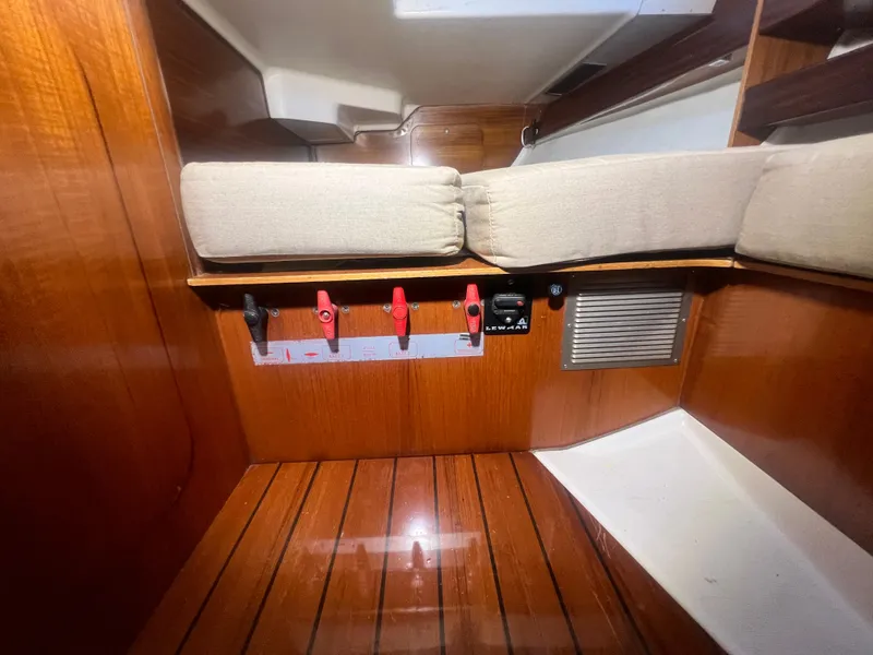 Slide: The Image of Interior of 1994 Beneteau Oceanis 440 yacht with wooden flooring and cushioned seating. - 47