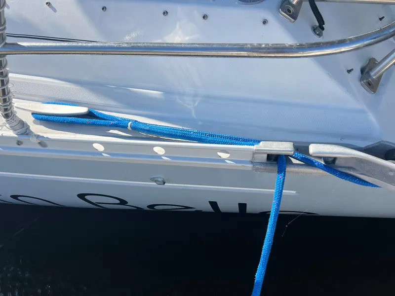 Slide: The Image of Beneteau Oceanis 440 sailboat, 1994 model, with blue mooring line and stainless steel railings. - 5