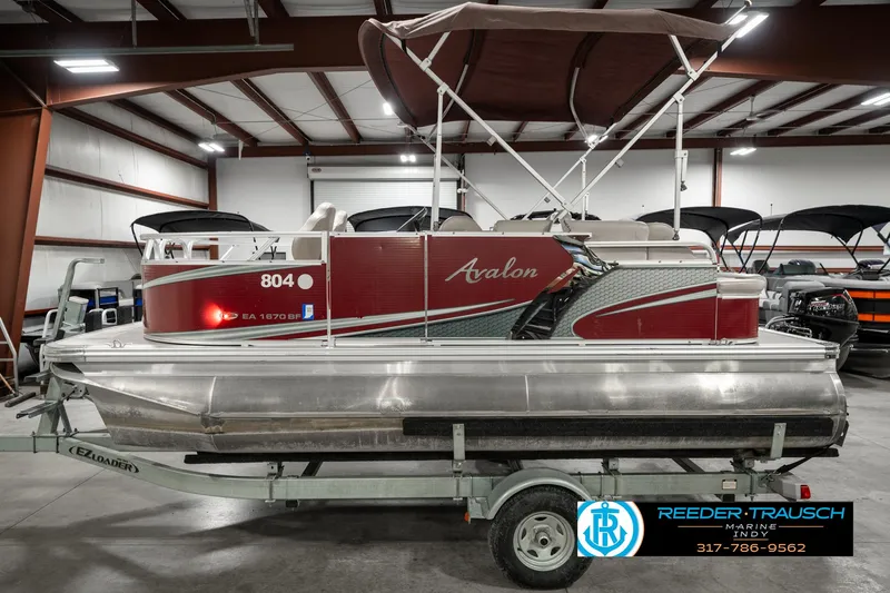 Slide: The Image of 2019 Avalon Eagle pontoon boat on trailer in indoor storage facility. - 11