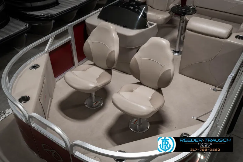 Slide: The Image of 2019 Avalon Eagle boat interior with beige seating and steering console. - 12