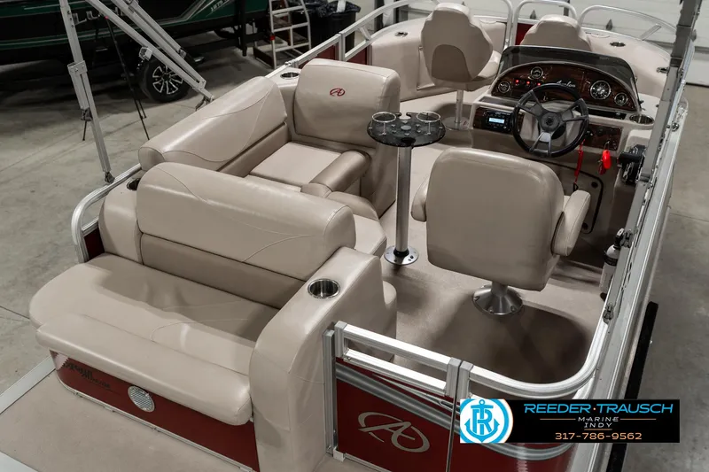 Slide: The Image of 2019 Avalon Eagle boat interior with beige seating and modern dashboard. - 14