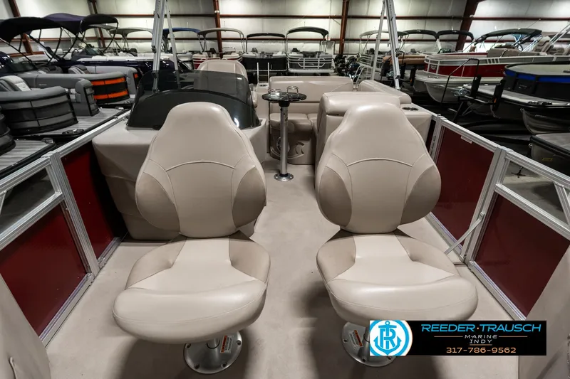 Slide: The Image of Interior of 2019 Avalon Eagle boat with beige seating and steering console. - 16