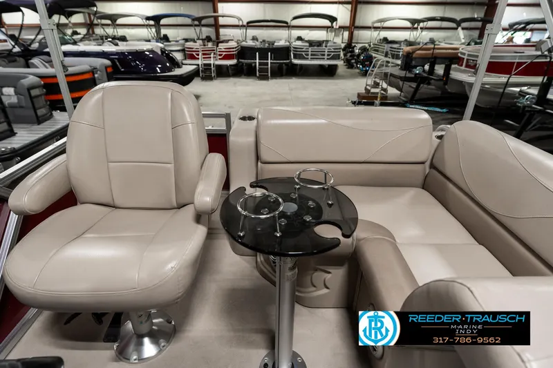 Slide: The Image of Luxurious seating on 2019 Avalon Eagle boat with cup holders, showcased in a showroom. - 17