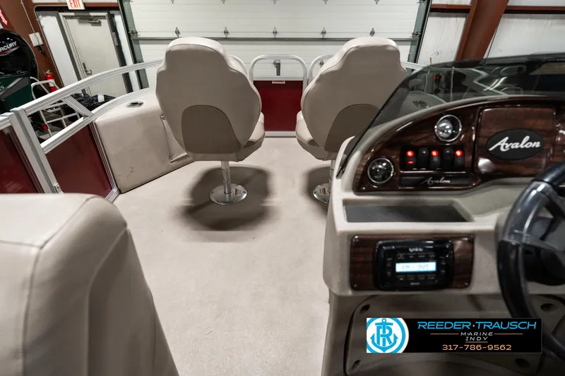 Slide: The Image of Interior of a 2019 Avalon Eagle boat with seating and control panel. - 19