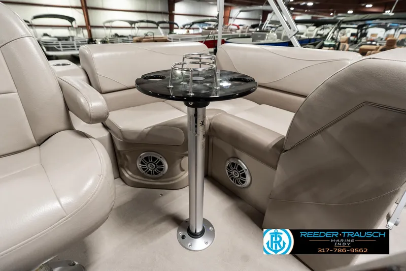 Slide: The Image of Interior of a 2019 Avalon Eagle boat with beige seating and a central table. - 20