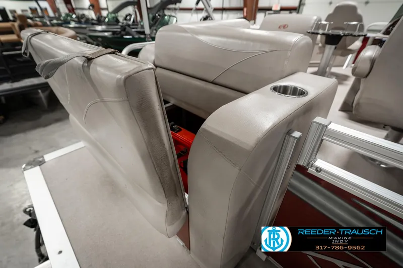 Slide: The Image of 2019 Avalon Eagle boat interior with beige seating and cup holder. - 24