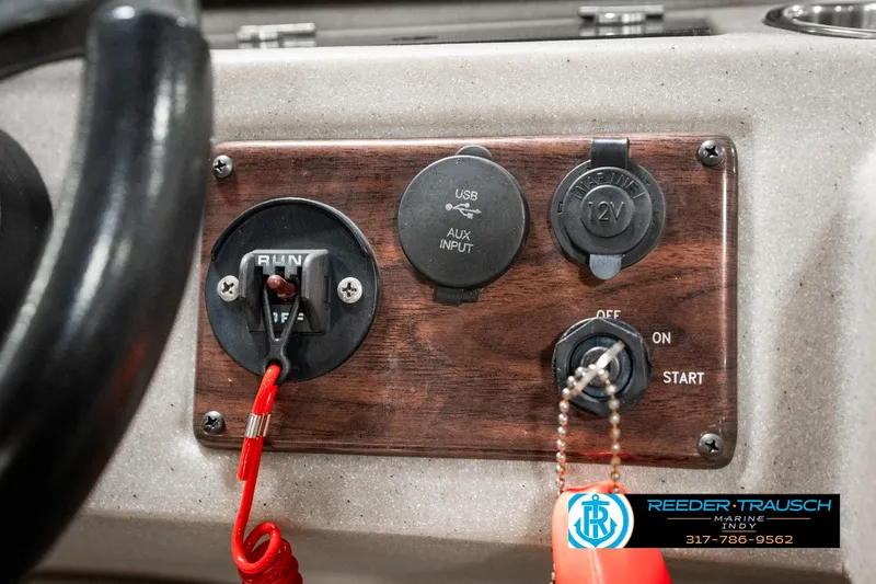 Slide: The Image of Control panel of a 2019 Avalon Eagle boat with ignition switch and auxiliary inputs. - 31