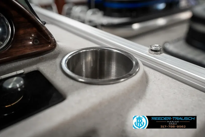 Slide: The Image of Cup holder on 2019 Avalon Eagle boat dashboard, featuring sleek design and metallic finish. - 36