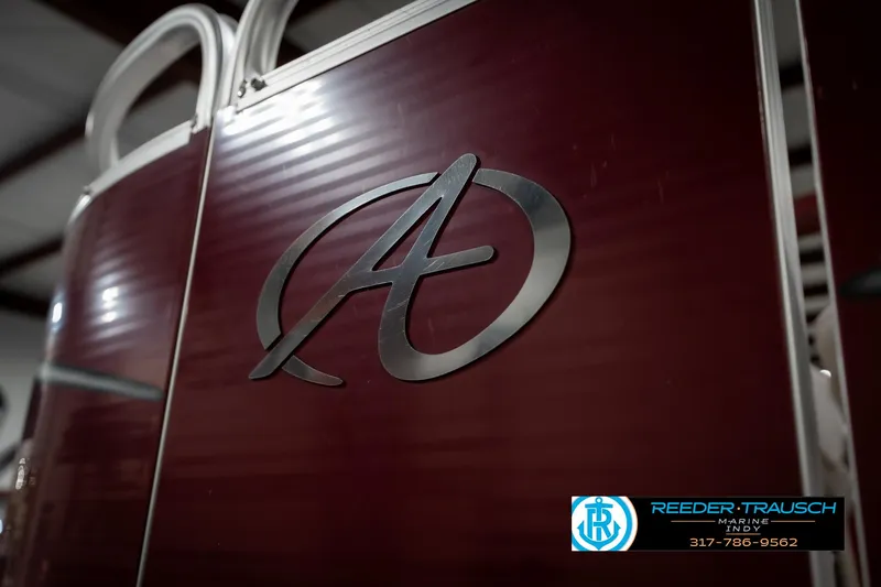 Slide: The Image of 2019 Avalon Eagle boat with logo, maroon paneling, and Reeder-Trausch branding. - 38