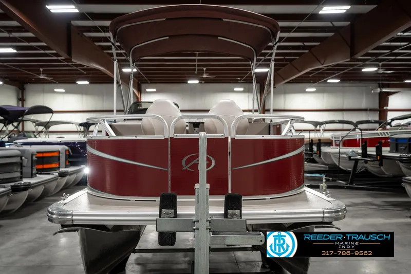 Slide: The Image of 2019 Avalon Eagle pontoon boat in showroom, featuring maroon exterior and canopy. - 5
