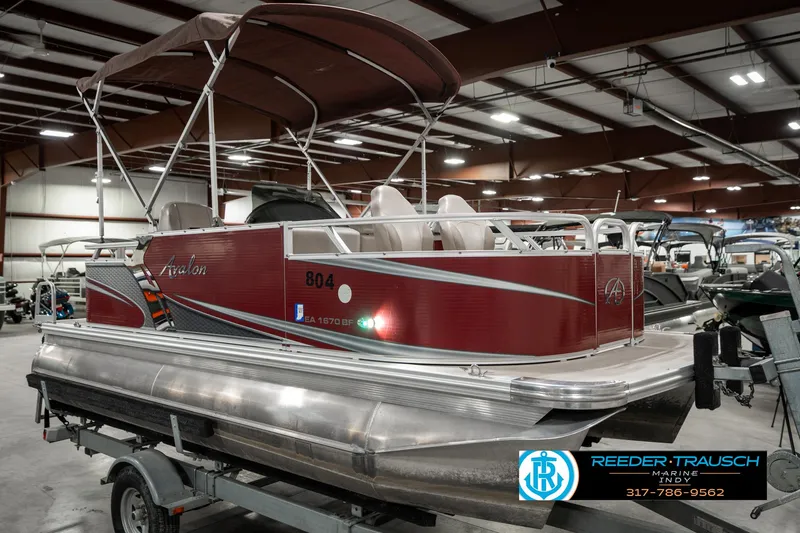 Slide: The Image of 2019 Avalon Eagle pontoon boat with canopy in indoor showroom. - 6