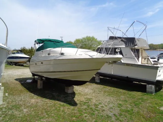 Slide: The Image of 2001 Regal Commodore 2760 boat on blocks, green canopy, parked outdoors. - 1