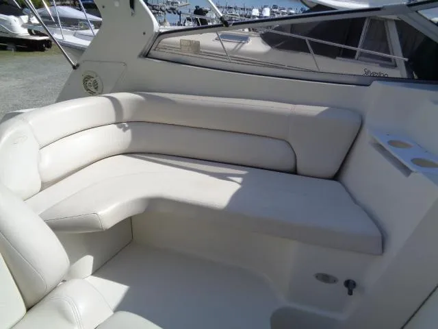 Slide: The Image of 2001 Regal Commodore 2760 boat interior with white cushioned seating. - 10