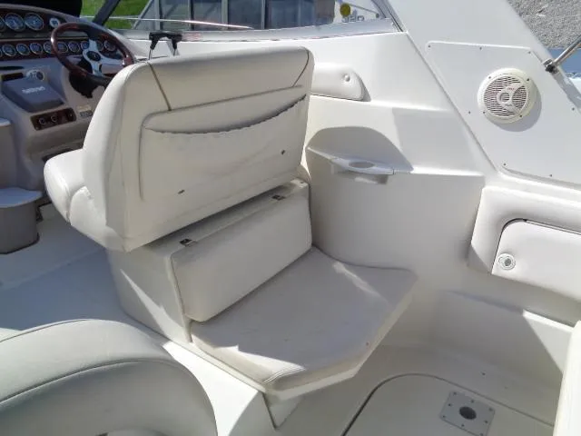 Slide: The Image of 2001 Regal Commodore 2760 boat interior with white seating and dashboard. - 11