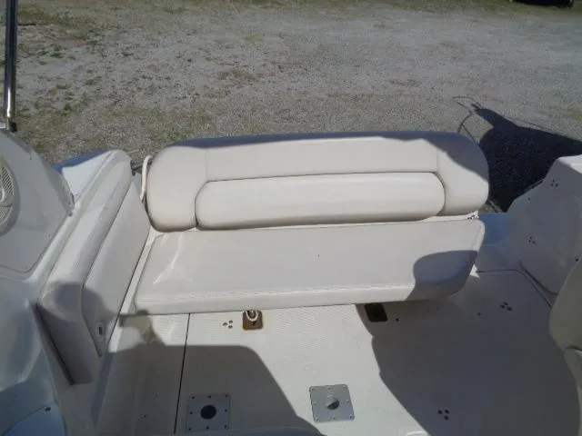 Slide: The Image of 2001 Regal Commodore 2760 boat interior with white cushioned seating. - 12
