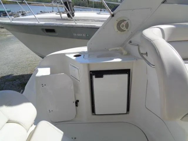 Slide: The Image of 2001 Regal Commodore 2760 boat interior with seating and mini fridge. - 13