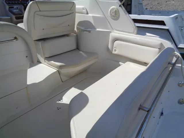 Slide: The Image of 2001 Regal Commodore 2760 boat interior with white seating and speaker. - 14
