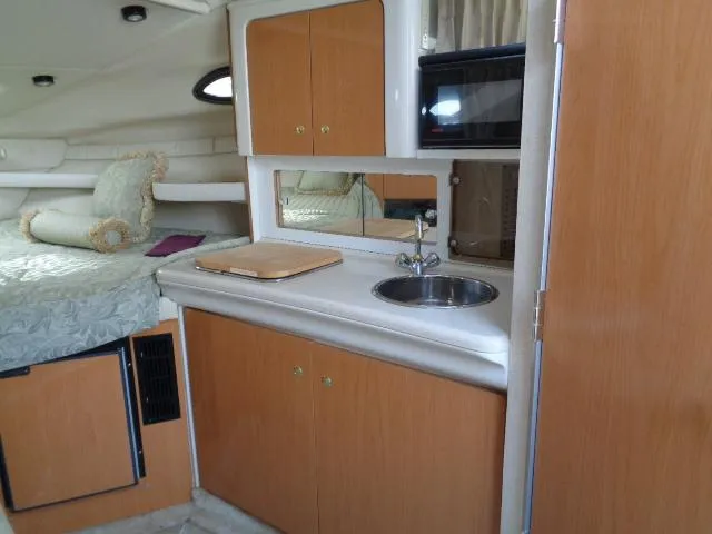 Slide: The Image of 2001 Regal Commodore 2760 boat interior with kitchenette and bed. - 18
