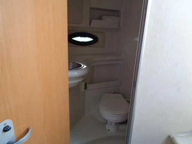 Slide: The Image of Interior bathroom of 2001 Regal Commodore 2760 boat, featuring toilet and sink. - 21