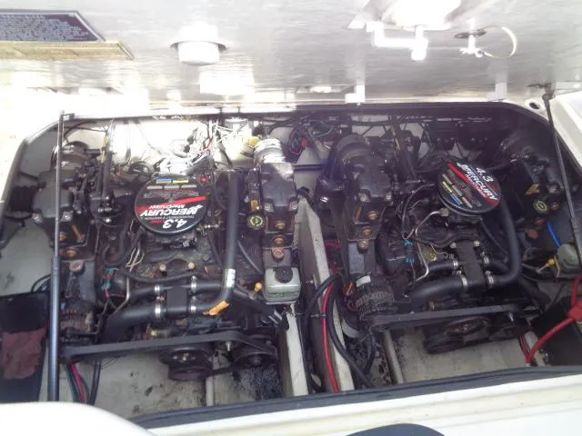 Slide: The Image of Engine compartment of a 2001 Regal Commodore 2760 boat, featuring dual engines. - 23