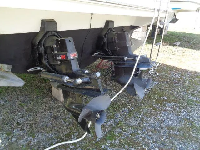 Slide: The Image of 2001 Regal Commodore 2760 boat with dual outboard motors on a grassy surface. - 26