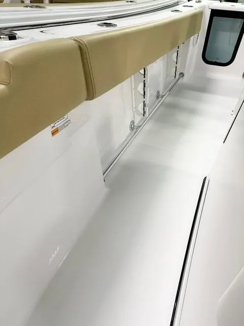 Slide: The Image of 2025 Sportsman Open 232 Center Console interior with cushioned seating and storage compartments. - 10