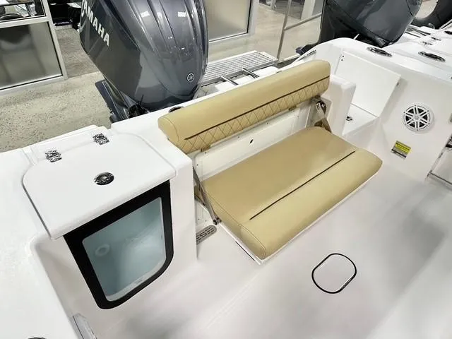 Slide: The Image of 2025 Sportsman Open 232 Center Console boat interior with tan seating and Yamaha engine. - 12