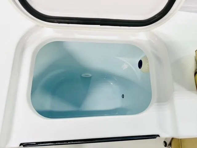 Slide: The Image of 2025 Sportsman Open 232 Center Console livewell, open lid, white interior. - 13