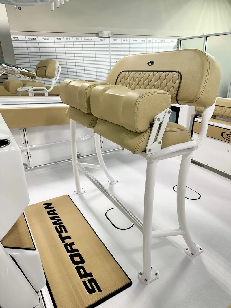 Slide: The Image of 2025 Sportsman Open 232 Center Console boat with beige seating and sleek design. - 4
