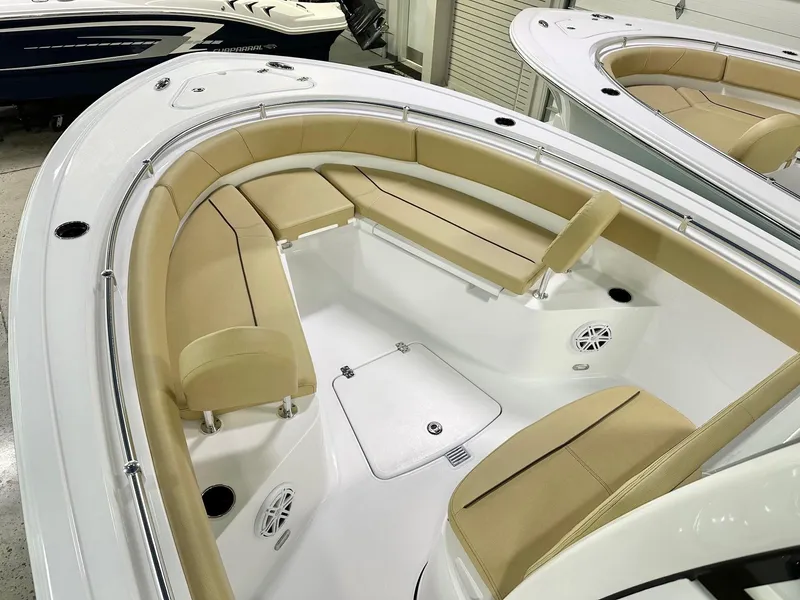 Slide: The Image of 2025 Sportsman Open 232 Center Console boat with tan seating and white deck. - 6