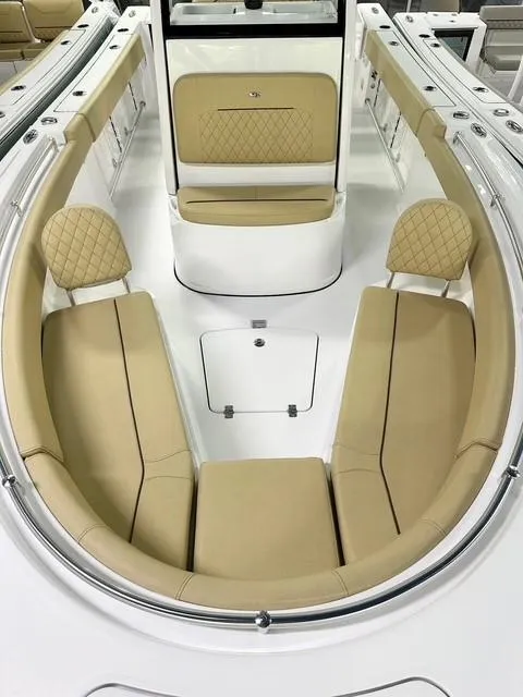 Slide: The Image of 2025 Sportsman Open 232 Center Console boat with tan seating and sleek design. - 7