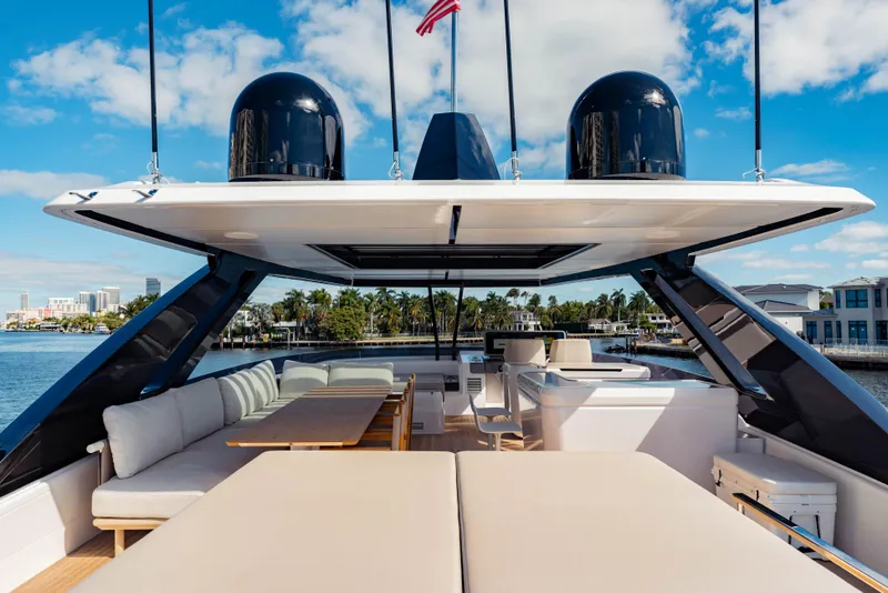 Slide: The Image of Luxurious 2023 Ferretti Yachts 860 with spacious deck and elegant seating under clear skies. - 28