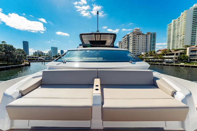 Slide: The Image of 2023 Ferretti Yachts 860, luxury yacht with spacious deck, city skyline backdrop. - 8