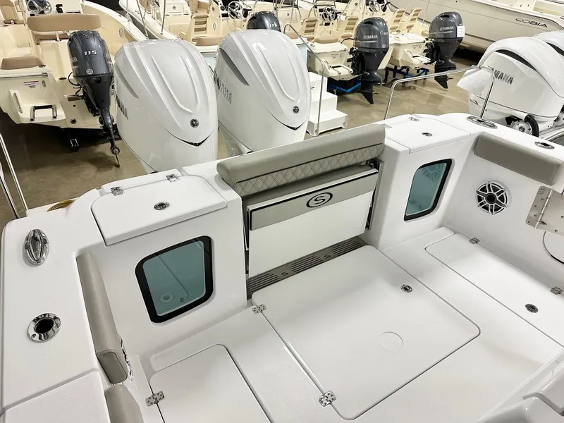 Slide: The Image of 2025 Sportsman Open 302 Center Console boat interior with Yamaha engines in showroom. - 12