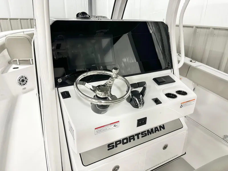 Slide: The Image of 2025 Sportsman Open 302 Center Console boat dashboard with steering wheel and controls. - 2