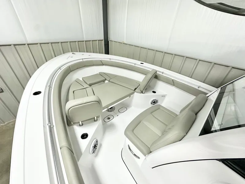 Slide: The Image of 2025 Sportsman Open 302 Center Console boat interior with cushioned seating and modern design. - 7