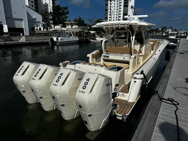 Slide: The Image of 2025 Scout 400 LXF boat docked with four powerful Mercury 400 V10 engines. - 15