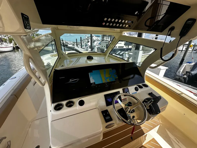 Slide: The Image of 2025 Scout 400 LXF boat cockpit with advanced navigation system and steering wheel. - 22