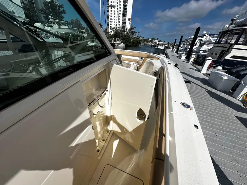 Slide: The Image of 2025 Scout 400 LXF boat docked, showcasing sleek design and luxurious features. - 23