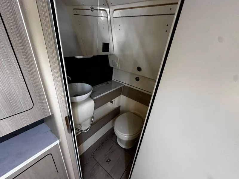 Slide: The Image of 2025 Scout 400 LXF boat bathroom interior with sink and toilet. - 31