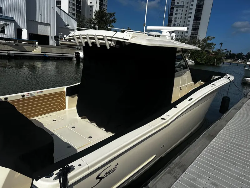 Slide: The Image of 2025 Scout 400 LXF boat docked at marina, showcasing sleek design and modern features. - 32
