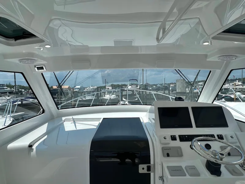 Slide: The Image of Interior view of 2025 Henriques 35 Express Hardtop yacht cockpit with navigation screens. - 13